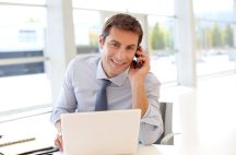 Portrait of businessman talking on mobile phone in office commercial